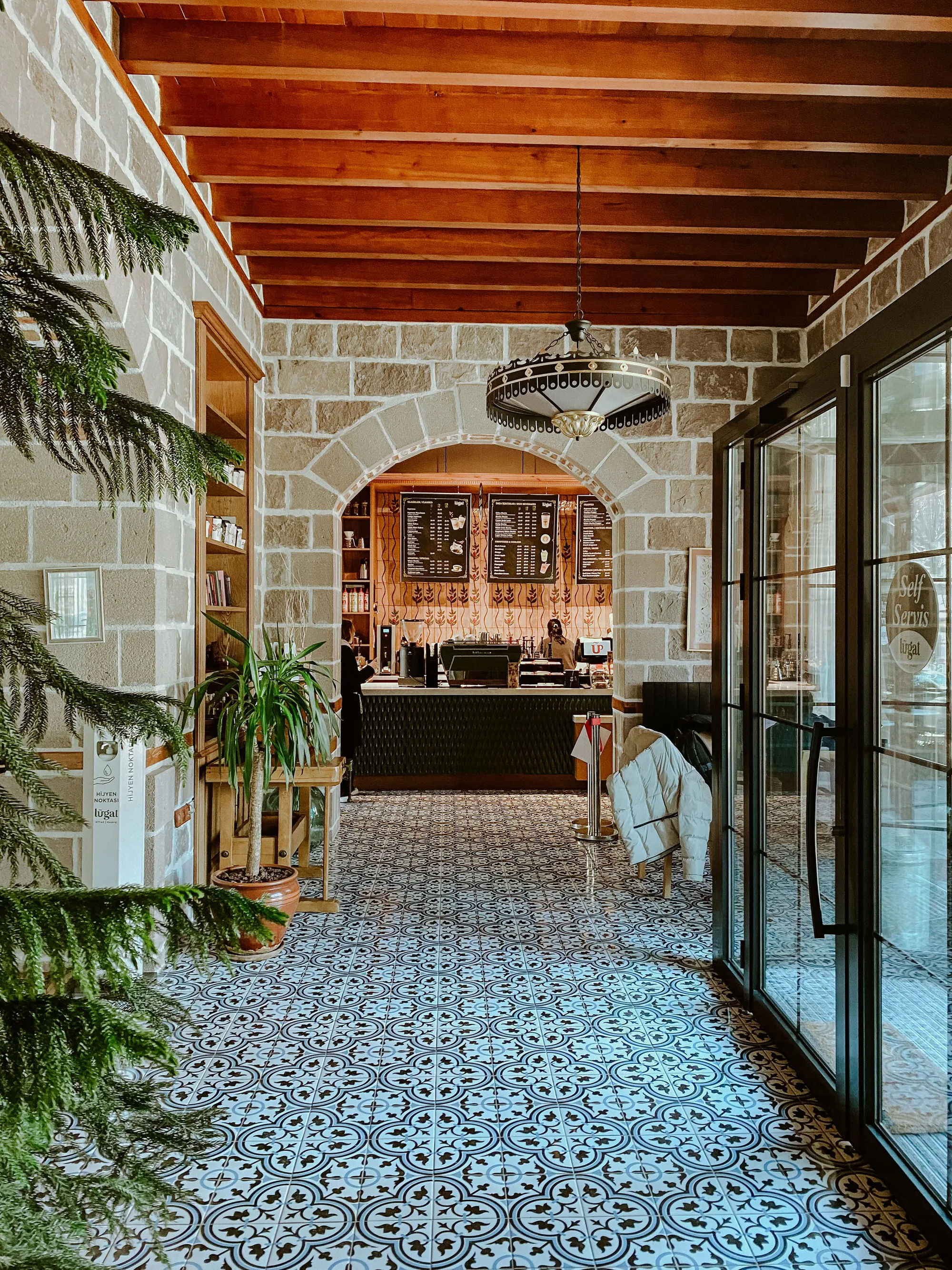 Patterned tile floor through an arched shopfront
